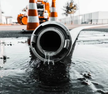 Water discharging from a large-diameter pipe during hydro jet cleaning